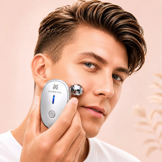 Person using a skincare facial roller on his face with a soft pink background