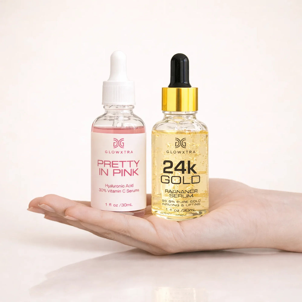 GlowXtra Pretty in Pink Vitamin C serum and 24K Gold Radiance Serum displayed on an open palm against a soft ivory background.